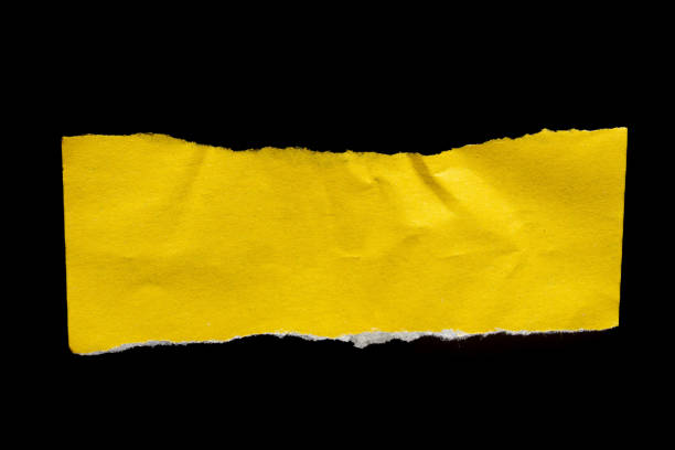 istock Ripped torn yellow paper piece on isolated black background 2160737761