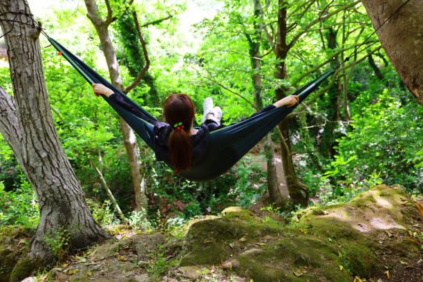 istock Young woman in hammock in forest 2160738287