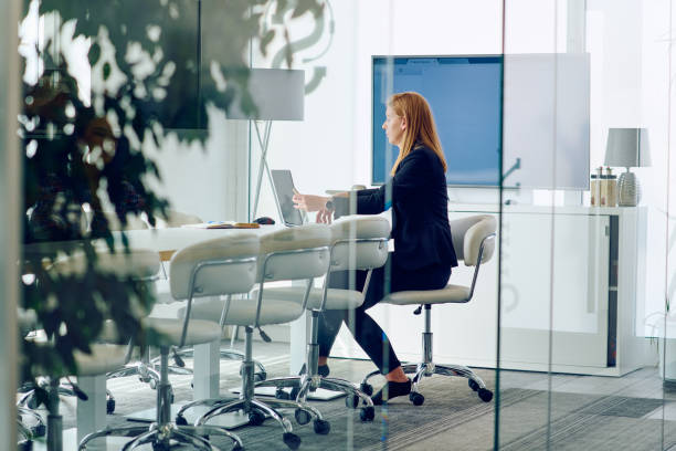 istock Businesswoman Working on Projects in Modern Glass Office Environment. 2160738375