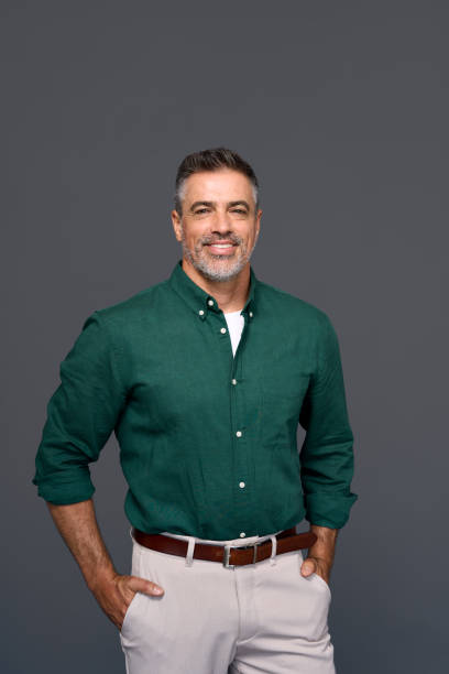 istock Stylish middle aged business man standing isolated on gray background. 2160741780