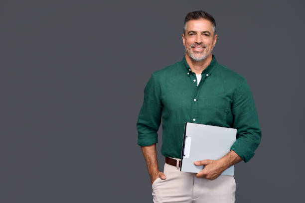 istock Happy middle aged business man presenting ads standing isolated on gray. 2160741786