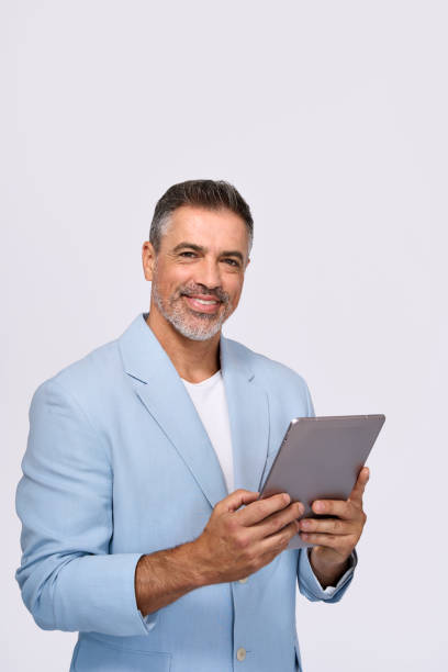 istock Happy middle aged business man wearing suit using digital tablet, isolated. 2160741879