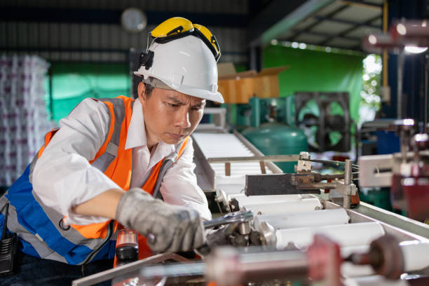 istock Factory workers inspect plastic bottle skin machines with tools 2160742672