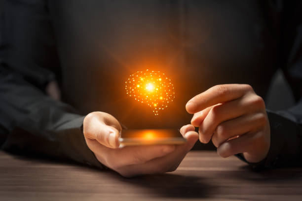 istock Artificial intelligence brain symbol on smartphone in men hand 2160744625