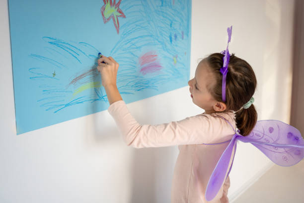 istock Girl dressed as a fairy drawing whit crayon 2160745206