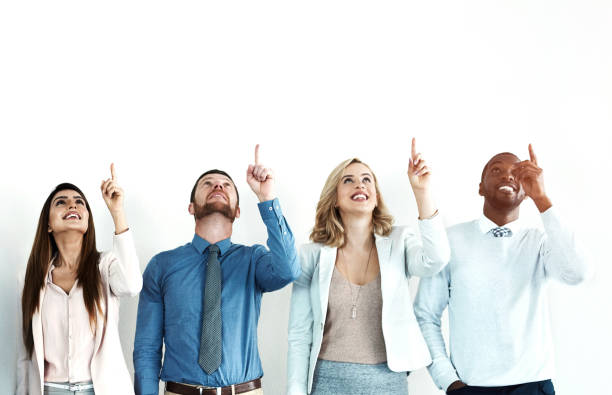 istock Business people, diversity and group pointing up, wall and mockup space with opportunity. Employees, teamwork and coworking with hand gesture, collaboration and decision with choice and suggestion 2160748535