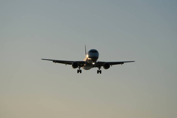 Airplane in the blue sky at sunset
