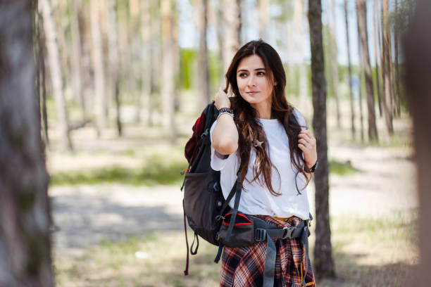 istock Relaxed female hiker enjoying walk in nature and looking away while having hiking 2160749802