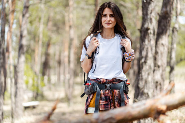 istock Positive woman with backpack and knit shirt looking at camera 2160749949