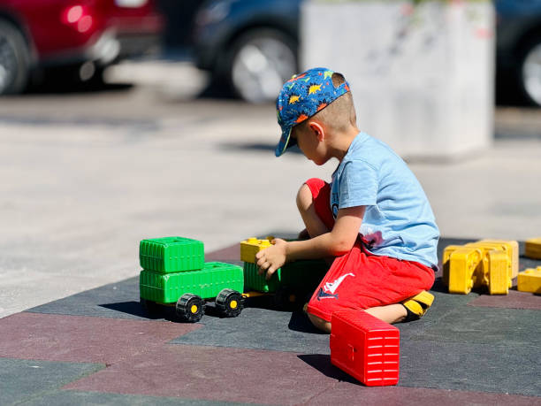istock Child Playing with Blocks and Trucks 2160753638