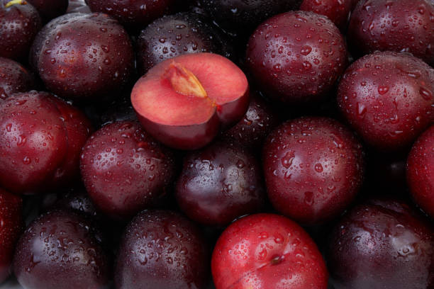 istock Plums fruits with water drops as background. 2160755064