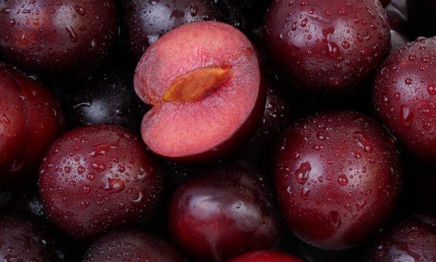 istock Plums fruits with water drops as background. 2160755074