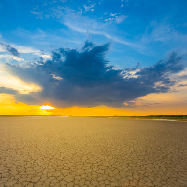 istock wide dry cracked earth at the dramatic sunset 2160756907