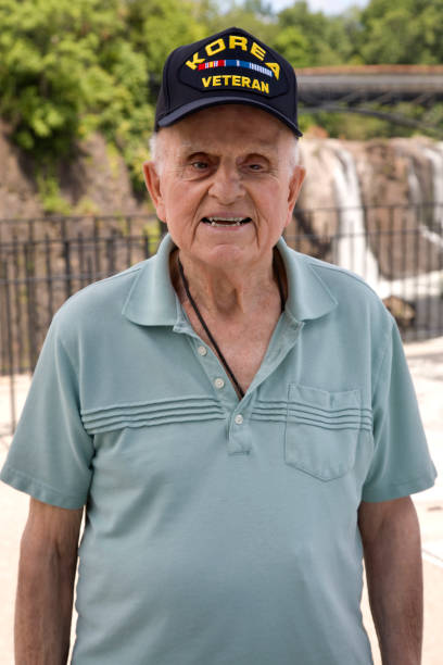 U.S. Veteran standing at observation point in a national park looking at camera.