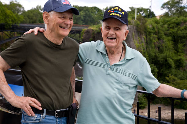 U.S. veterans laughing in front of scenic background