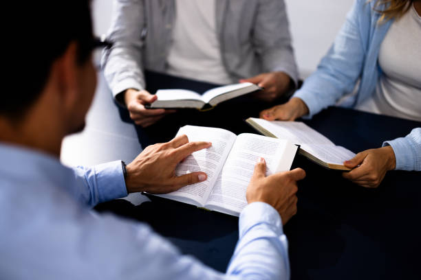 istock Christian Preacher Reading Holy Bible With Friends in Study Circles, Hispanic 2160759537