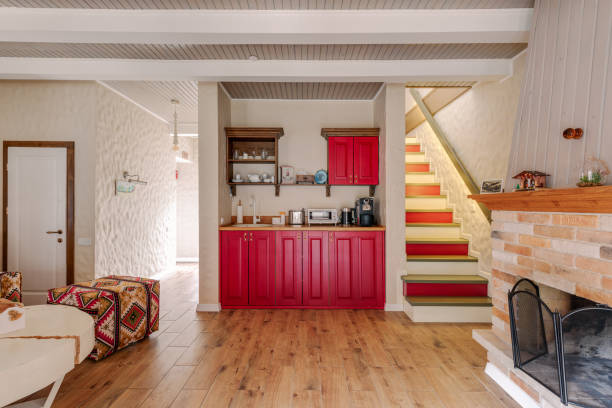 istock Charming kitchen with red cabinets and rustic staircase, creating a cozy atmosphere 2160760004
