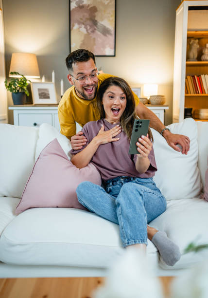 istock Couple looking surprised at a mobile phone 2160761758