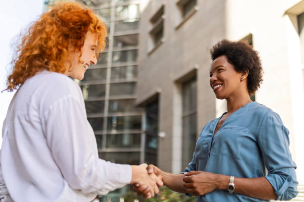 istock Business Colleagues Shaking Hands Outside 2160762372
