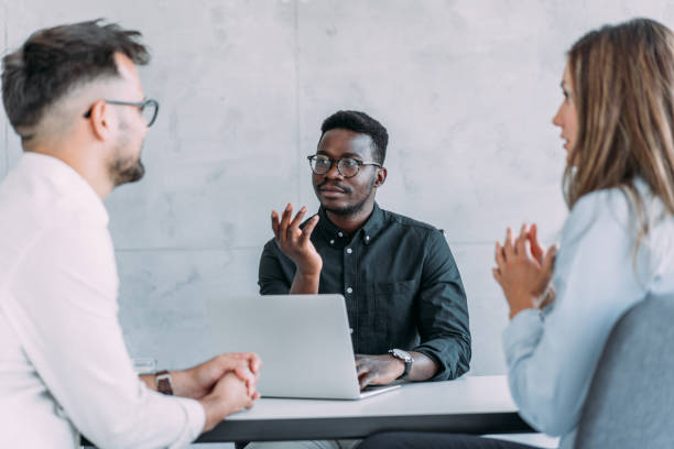istock Group of business persons talking in the office. 2160767841