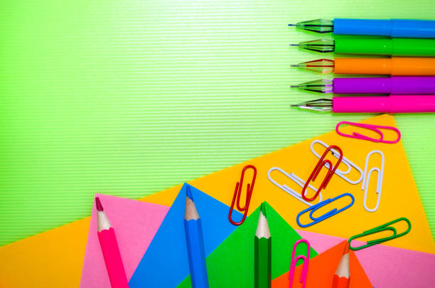 Welcome Back to school concept Horizontal banner school equipment on green background Office supplies Copy space for text Colored pencils pens paper clips Flat lay educational themes Colored paper