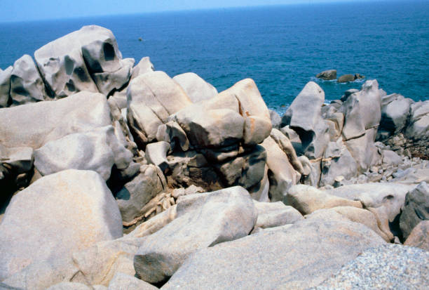 Sardinia, Italy - 20 July 1986: the wild nature, the turquoise sea and rocks of all sizes and shapes constantly smoothed by the wind and the sea make the views of Sardinia absolutely unique