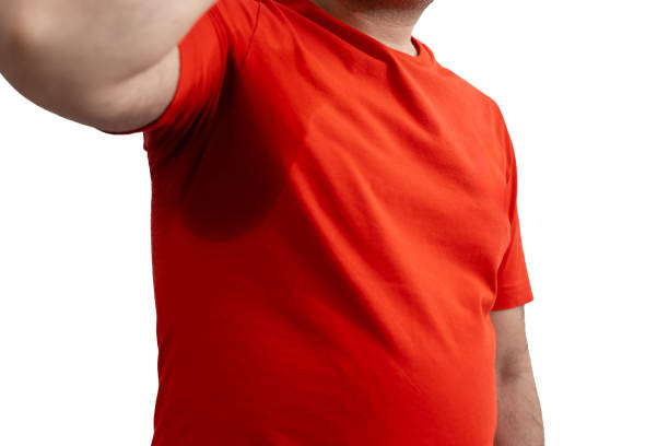 A man with a red t-shirt drenched in sweat