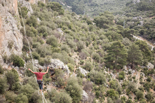 istock A man walks on a tightrope over an abyss. 2160773127