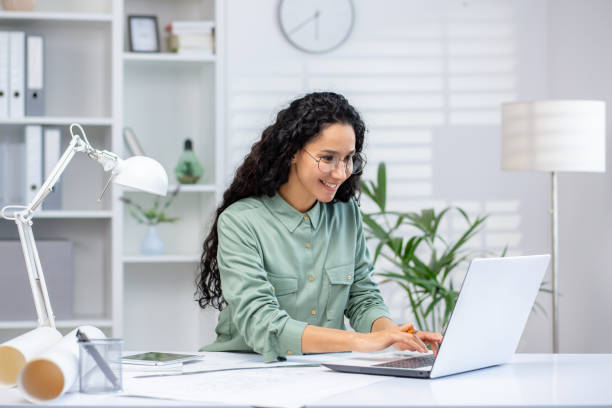 istock Architect working on laptop in modern office with natural light and stylish decor 2160775295