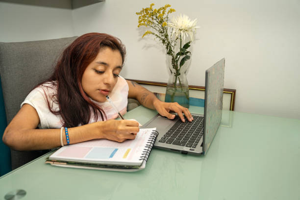 istock A young woman with osteogenesis imperfecta and dwarfism using a laptop at home doing remote work and home office. 2160780823