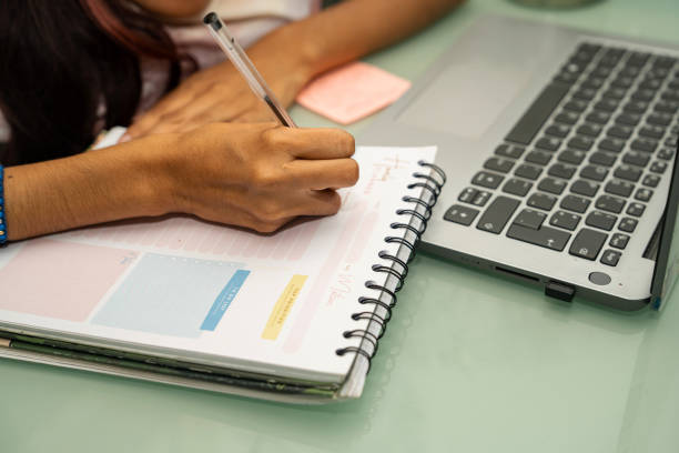 istock A young woman with osteogenesis imperfecta and dwarfism using a laptop at home doing remote work and home office. 2160780838