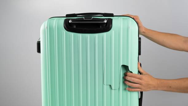 istock A woman demonstrates a broken suitcase on a white background. Damaged baggage during the flight. 2160781917