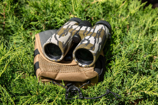 istock Modern binoculars. An optical instrument for observation at long distances. Green fir background. 2160782883