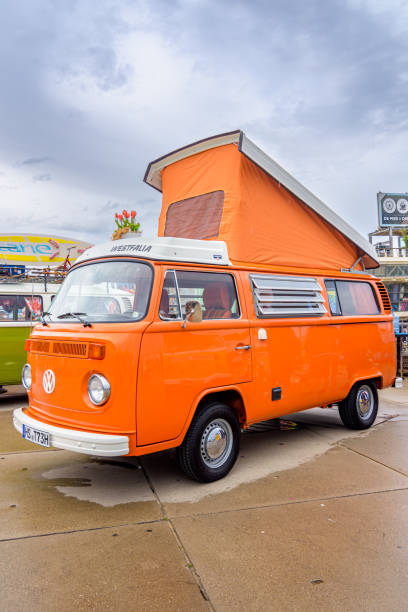 1970s classic Volkswagen Transporter T2 pick up parked in a field during a summer day. The second generation of the Volkswagen Type 2 (T2) was built from 1967–1979 by VW.