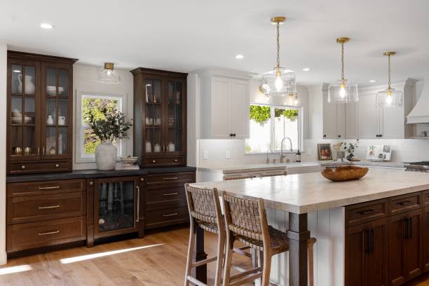 istock Modern kitchen interior with wooden cabinets, island, and pendant lighting. 2160788574
