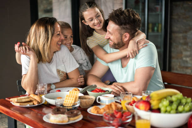 istock Family embracing during breakfast 2160789411