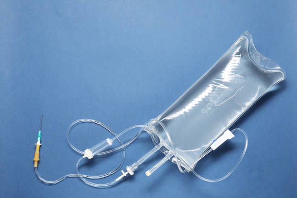 istock IV infusion set on blue background, top view. Space for text 2160796903