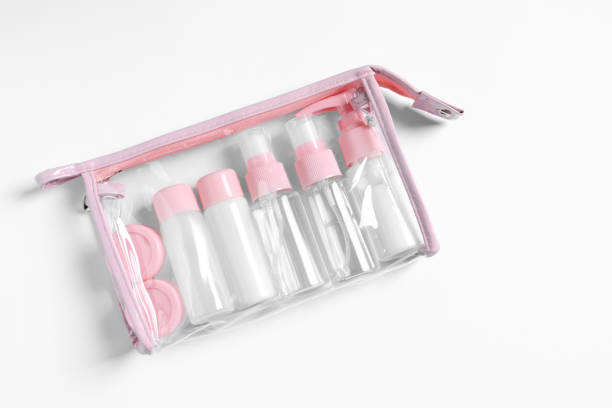istock Cosmetic travel kit in plastic bag on white background, top view. Space for text 2160796940