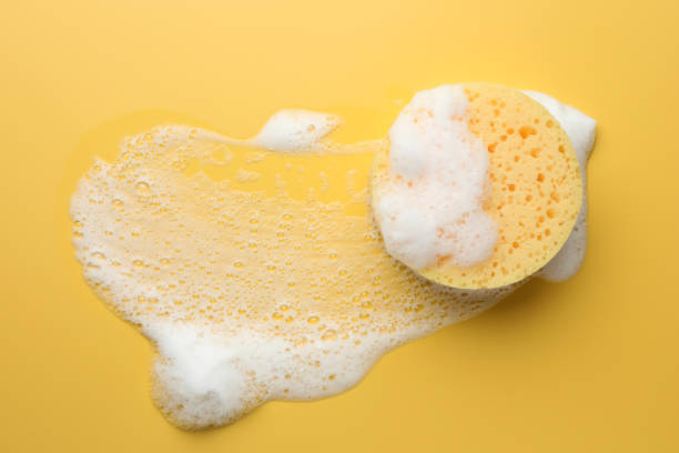 istock Sponge with foam on yellow background, top view 2160797019
