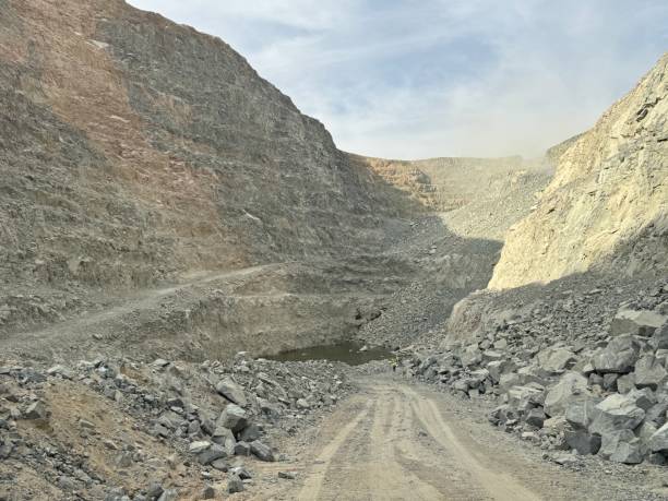 istock Ore trucks in an open-pit mine, Open pit mine, Heavy machinery in mine 2160798051