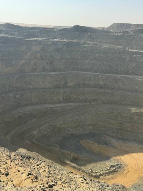 istock Ore trucks in an open-pit mine, Open pit mine, Heavy machinery in mine 2160798112