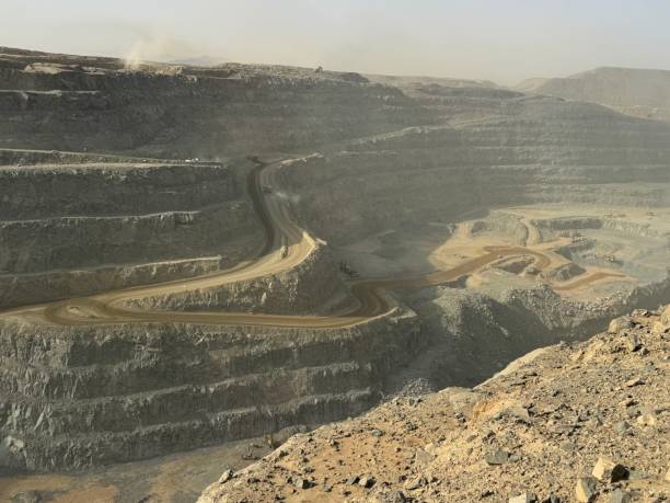 istock Ore trucks in an open-pit mine, Open pit mine, Heavy machinery in mine 2160798173