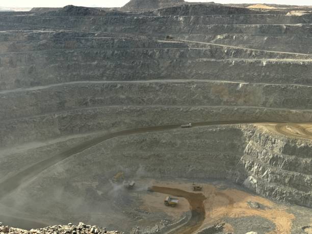 istock Ore trucks in an open-pit mine, Open pit mine, Heavy machinery in mine 2160798189