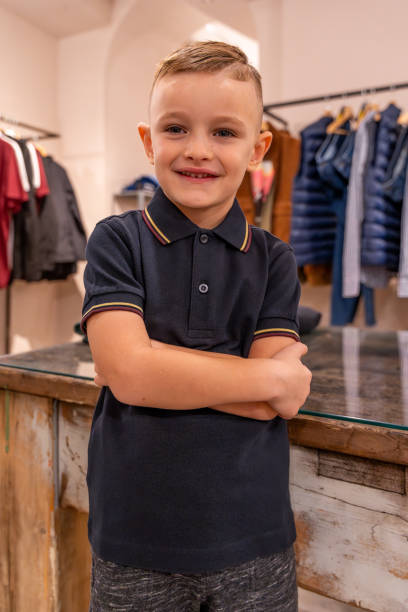 istock young child having fun posing as a model in a clothing store 2160798616