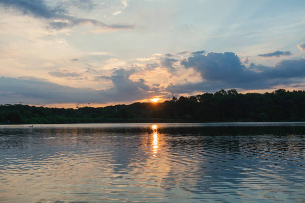 Sunrise on a cloudy summer day at Artist Lake in Middle Island,  Suffolk County,  Long Island,  NY.