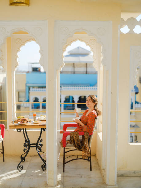 istock Woman having breakfast  on balcony  during trip to India 2160805767