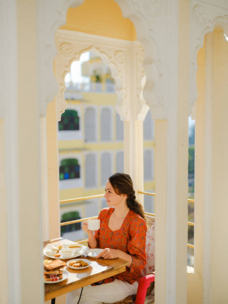 istock Woman having breakfast  on balcony  during trip to India 2160805771