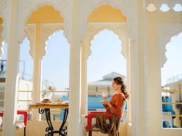 istock Woman having breakfast  on balcony  during trip to India 2160806357