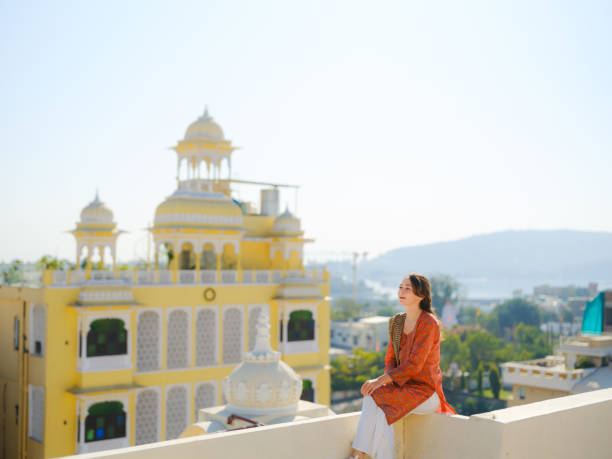 istock Woman sitting on balcony  during trip to Udaipur 2160806573