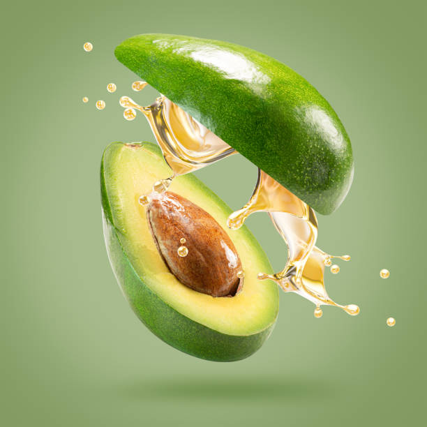 istock avocado with oil splash on a light green background 2160808149